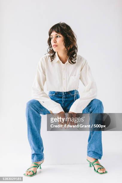 portrait of young adult caucasian woman sitting - sitting stock pictures, royalty-free photos & images