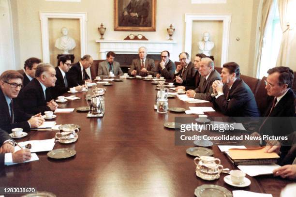 Israeli Foreign Minister Yitzhak Shamir and advisors meet with US President Ronald Reagan and advisors in the White House's Cabinet Room, Washington...