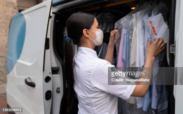 dry cleaners making a delivery service wearing a facemask - dry cleaned stock pictures, royalty-free photos & images