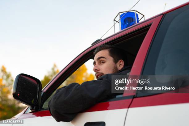 caucasian firefighter inside fire truck - police van stock pictures, royalty-free photos & images