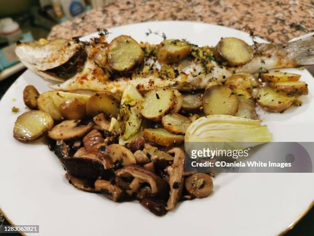 baked seabass on a plate - white mushroom ストックフォトと画像