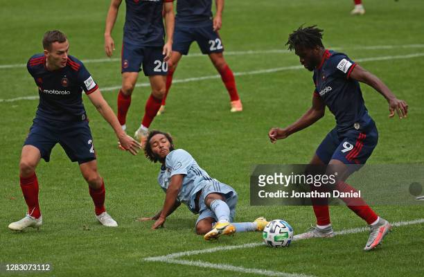 Gianluca Busio of Sporting Kansas City pushes the ball between Boris Sekulic and C.J. Sapong of Chicago Fire at Soldier Field on October 17, 2020 in...