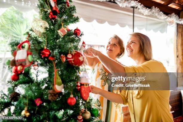 family decorating christmas tree - summer christmas stock pictures, royalty-free photos & images