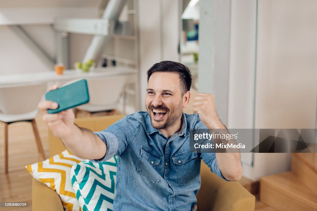 Young man having a video call at home
