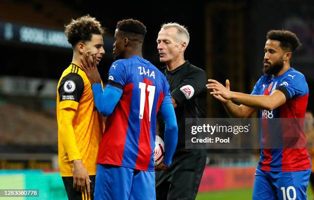 Wilfried Zaha of Crystal Palace handles Rayan Ait-Nouri of Wolverhampton Wanderers' face as they clash during the Premier League match between...