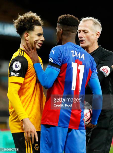 Wilfried Zaha of Crystal Palace handles Rayan Ait-Nouri of Wolverhampton Wanderers' face as they clash during the Premier League match between...