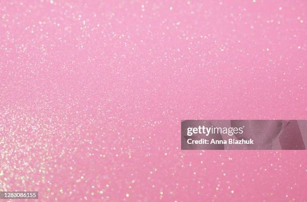 glitter festive pastel pink background with blurred sparkles, christmas, birthday or holiday background - scintillante foto e immagini stock