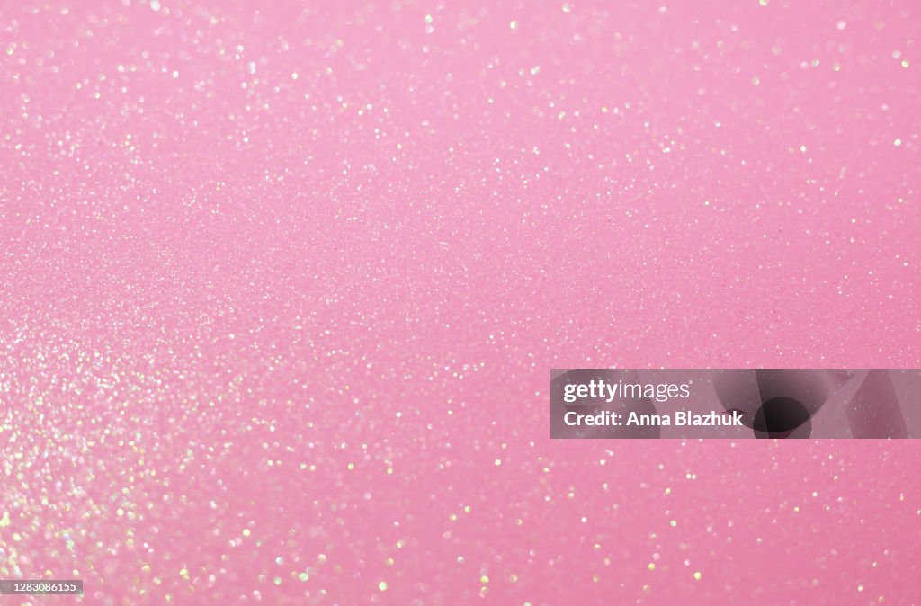 Glitter festive pastel pink background with blurred sparkles, Christmas, birthday or holiday background