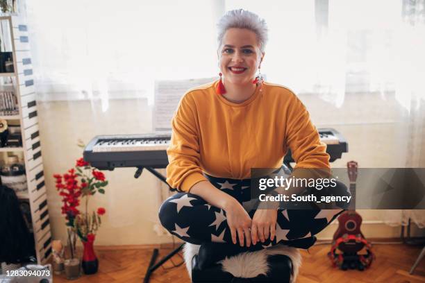 female pianist sitting in front of electric piano at home - pianist front stock pictures, royalty-free photos & images