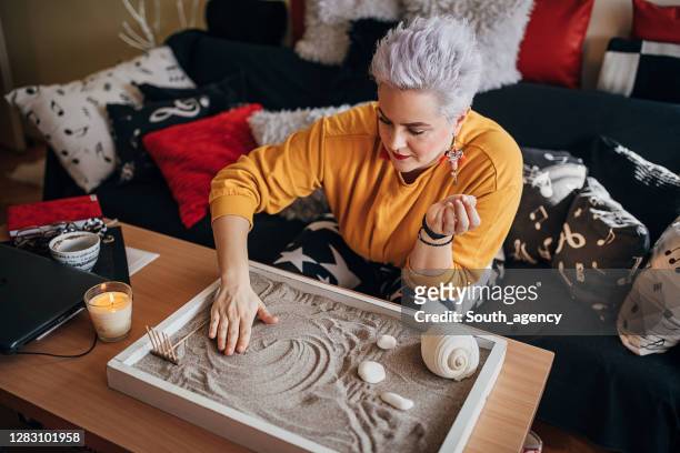 woman relaxing with zen garden at home - karesansui stock pictures, royalty-free photos & images
