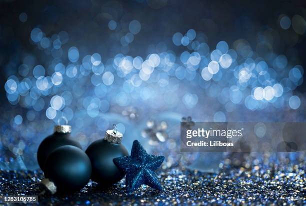 christmas blue baubles on a blue background - blue baubles stock pictures, royalty-free photos & images