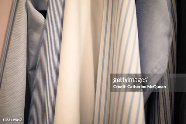 background of various shades & patterns of men’s dress shirts hanging in closet - mens fashion wallpaper bildbanksfoton och bilder