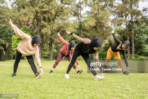 Islamic Exercise Programmes Muslim Girls Exercise Stretching In A Park High-Res Stock Photo - Getty ...