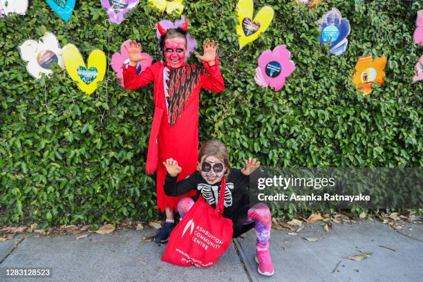 Two young girls celebrating Halloween pose for a photo on October 31, 2020 in Melbourne, Australia. Lockdown restrictions in Melbourne were lifted on...