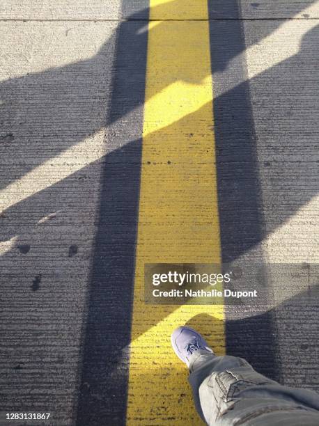 yellow and black marking on airport tarmac - airport above stock-fotos und bilder