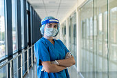 young nurse in blue uniform and protective shield to protect against a new dangerous virus covid19