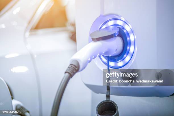 charging of an electric car - tesla motors stock pictures, royalty-free photos & images