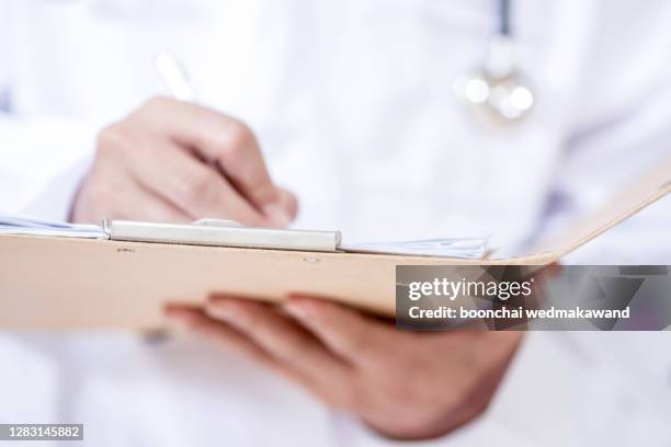 doctors write prescriptions - policies and procedures stock pictures, royalty-free photos & images