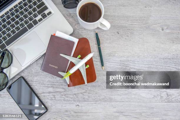 passport with an office desk. - coffee top view stock-fotos und bilder