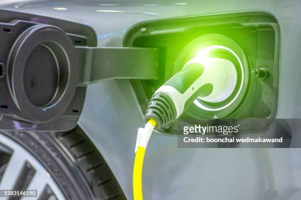 charging of an electric car - cars on motor way stock-fotos und bilder