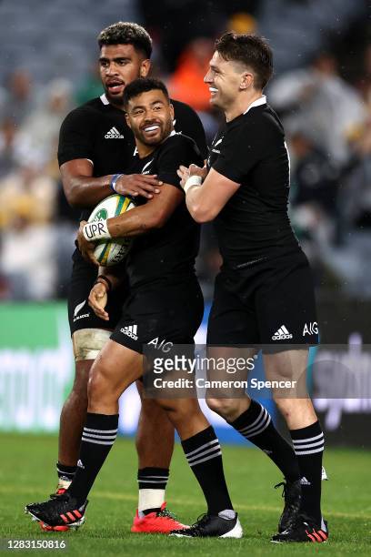 Richie Mo'unga of the All Blacks celebrates with Beauden Barrett and Hoskins Sotutu of the All Blacks after running in to score his second try during...