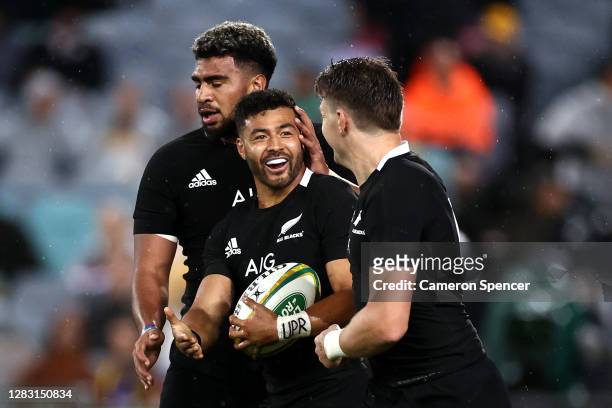 Richie Mo'unga of the All Blacks celebrates with Beauden Barrett and Hoskins Sotutu of the All Blacks after running in to score his second try during...