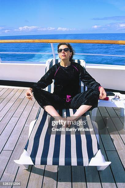 woman doing yoga on deck of cruise ship, ak - boat deck stock pictures, royalty-free photos & images