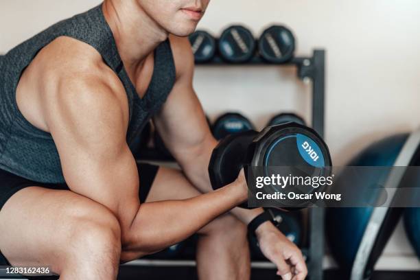 muscular young man training at gym - musculation des biceps photos et images de collection