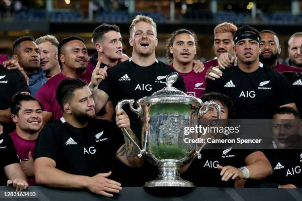 The All Blacks celebrate with the Bledisloe Cup after winning the 2020 Tri-Nations and Bledisloe Cup match between the Australian Wallabies and the...