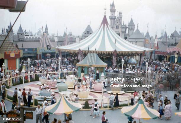 Disneyland, the only theme park designed and built to completion under the direct supervision of Walt Disney, opens with attendees enjoying the Mad...