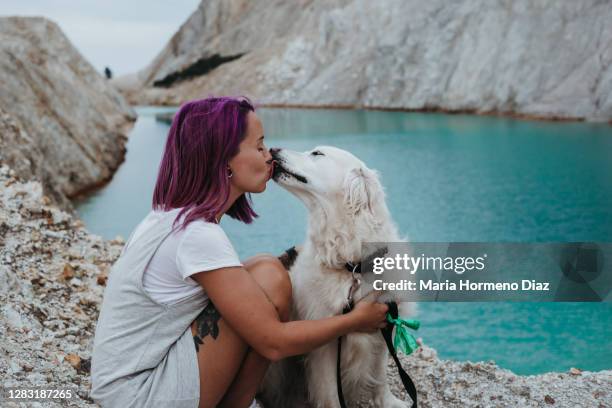young woman walking with her dog through an abandoned tungsten mine - cabello morado fotografías e imágenes de stock
