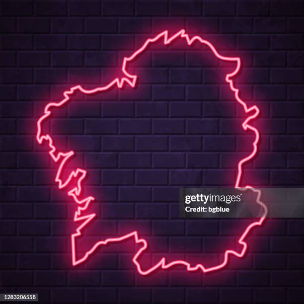 galicia map - glowing neon sign on brick wall background - santiago de compostela stock illustrations