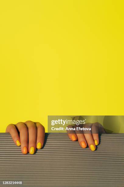 crop woman with rolled up mat. - nagelkunst stockfoto's en -beelden