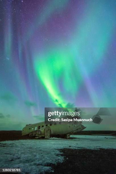 aurora borealis over douglas dc-3 plane wreckage - south south awards stock pictures, royalty-free photos & images