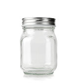 Empty glass jar with silver lid isolated on white.