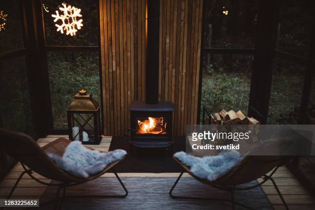 cozy place for rest - fireplace christmas stock pictures, royalty-free photos & images