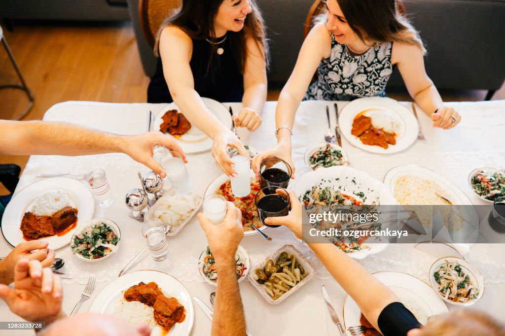 Close up of friends having fun and toasting and celebrating with turkish rakı