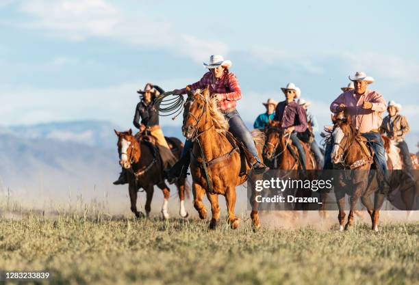 group of cowboys and cowgirls riding galloping horses in usa - horse riding group stock pictures, royalty-free photos & images