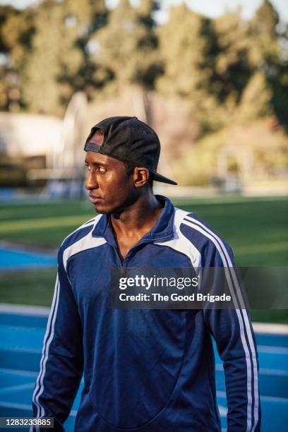 portrait of a man wearing a baseball hat backwards - tracksuit top stock pictures, royalty-free photos & images