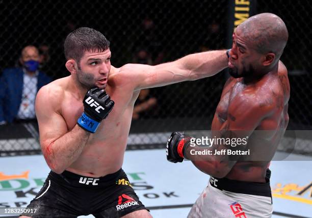 Thiago Moises of Brazil punches Bobby Green in a lightweight bout during the UFC Fight Night event at UFC APEX on October 31, 2020 in Las Vegas,...