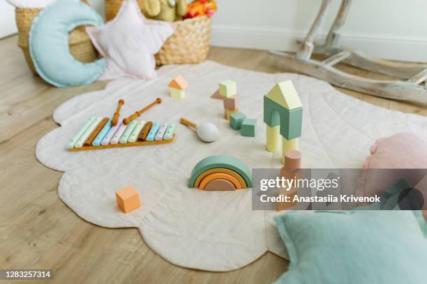 empty children's playroom full of natural wood toys. - playroom stock-fotos und bilder