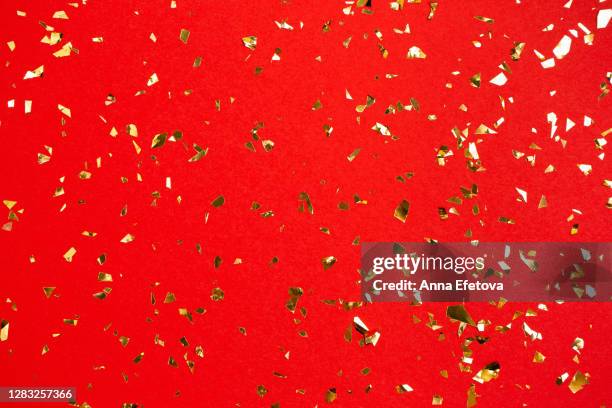confetti falling against red background - confetti gold ストックフォトと画像