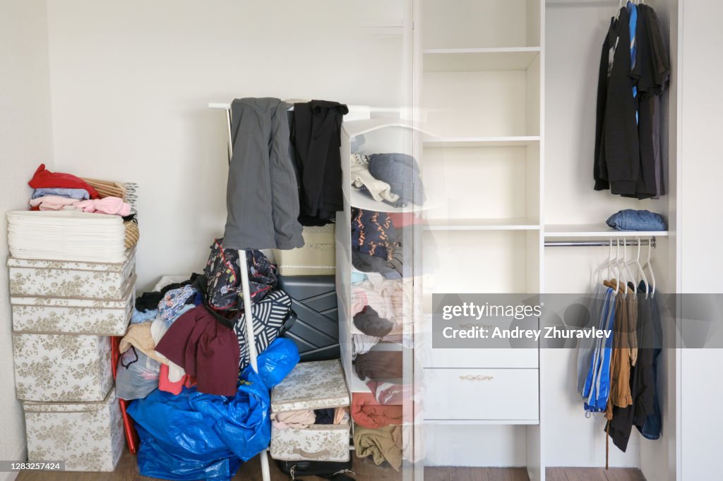 Clothes lay in a pile on the floor before installing the cabinet and hang neatly on a hanger after