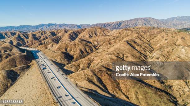 the drone aerial view of the ronald reagan freeway in the california mountains, nearby los angeles and la canada - angeles crest highway stock pictures, royalty-free photos & images