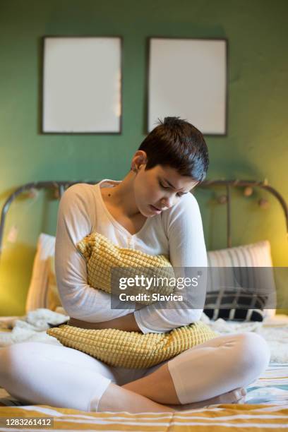 woman suffering from menstrual pains - bowel cancer stock pictures, royalty-free photos & images