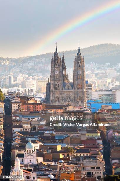 basilica del voto nacional and a rainbow, quito - quito stock pictures, royalty-free photos & images