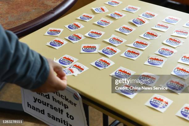 Staff member works at a polling station during early voting for the U.S. Presidential election on October 31, 2020 in Arlington, United States.