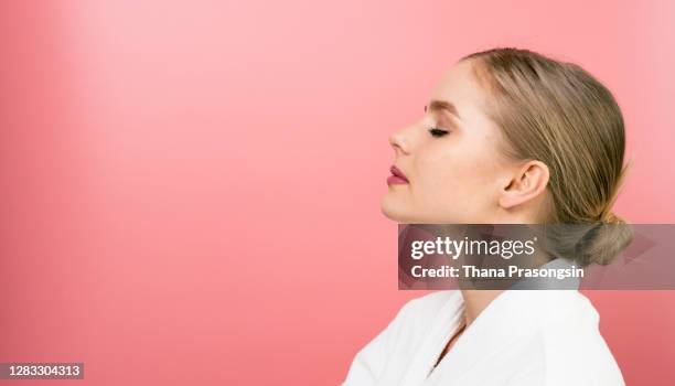 applying skin cream on a woman's face - portrait solid stock pictures, royalty-free photos & images