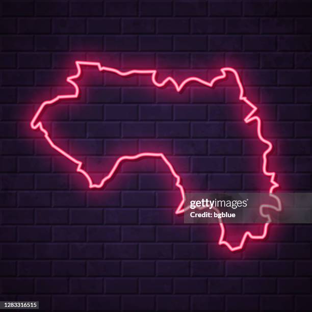 guinea map - glowing neon sign on brick wall background - led light wall stock illustrations