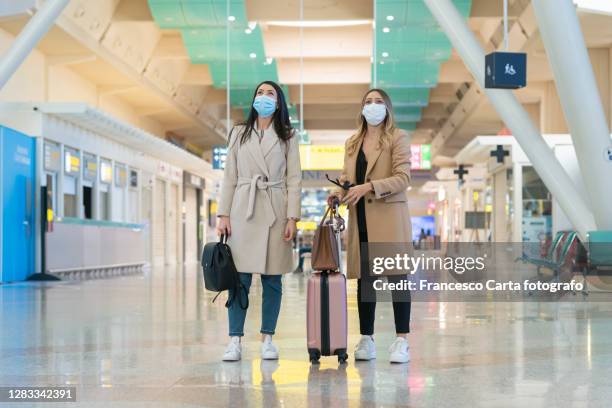 women at the airport in covid-19 time - medical tourism stock pictures, royalty-free photos & images